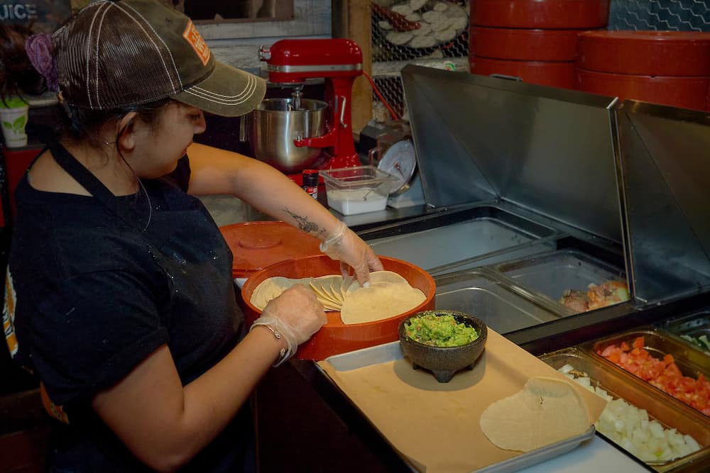 employee making fresh guacamole and tortillas at Fort Worth Steakhouse in sevierville